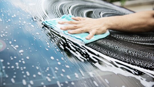 man-wash-car-using-shampoo